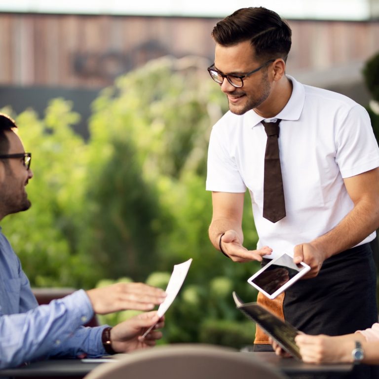 Waiter showing guests menu