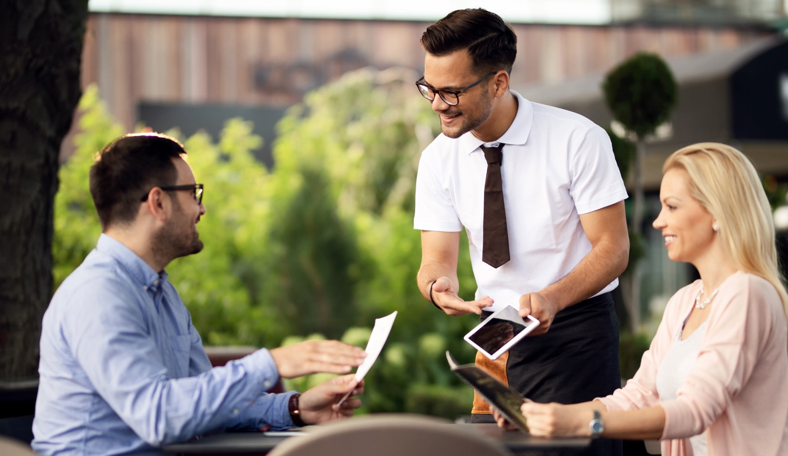 Waiter showing guests menu