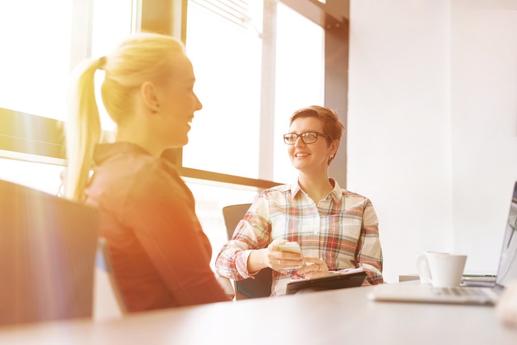 Two colleagues having a one-on-one meeting at the 