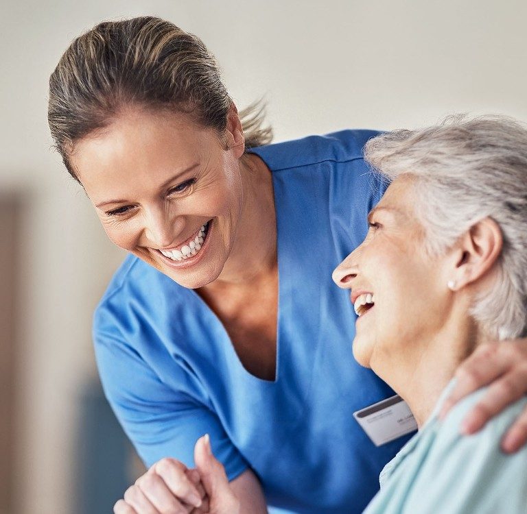 nurse comforting older lady