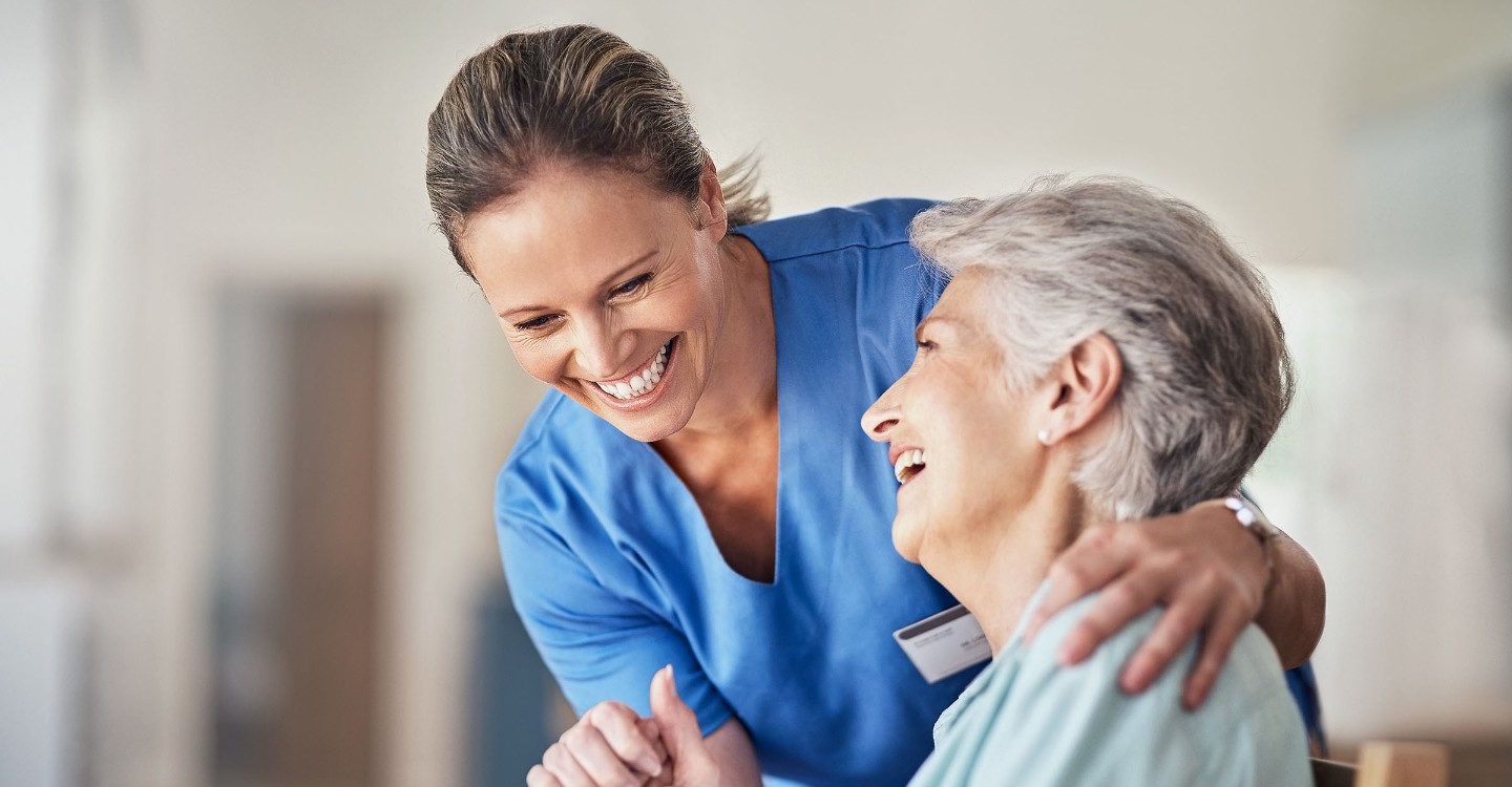 nurse comforting older lady